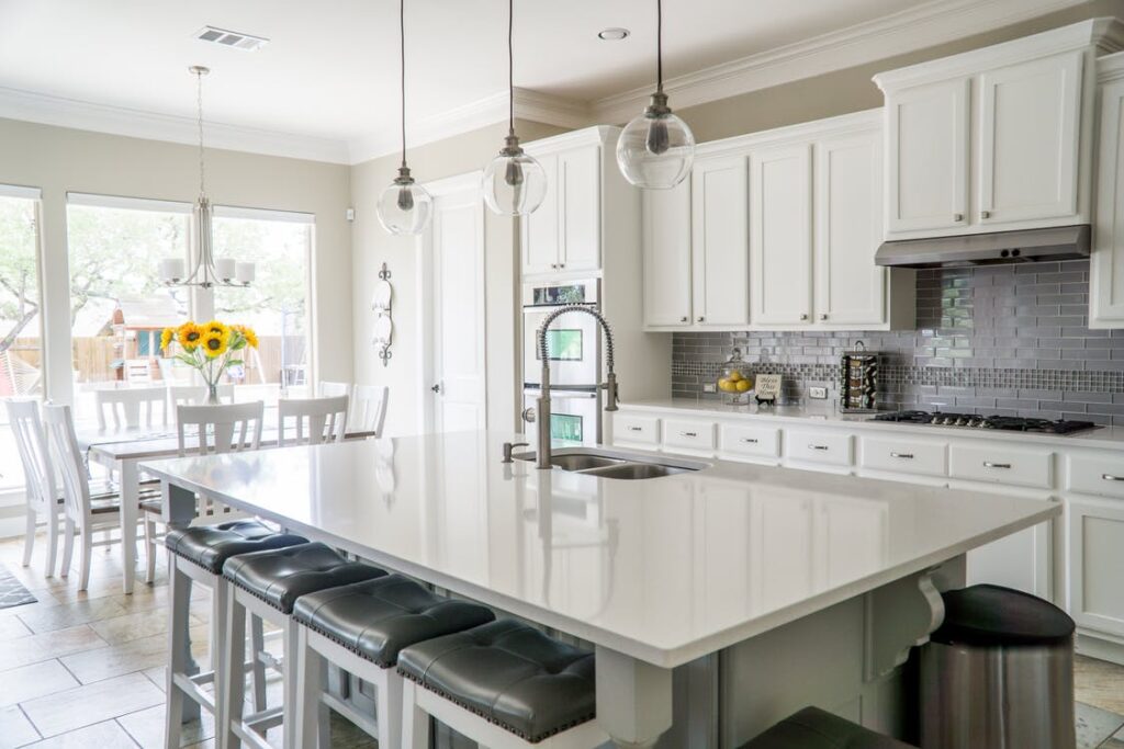 well-lit kitchen with open windows and hanging lights