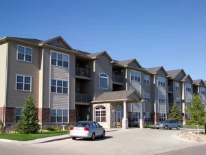 exterior of a row of three story apartments - project