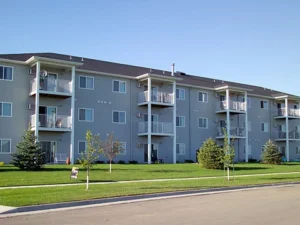 exterior of three-story apartment building in shadow